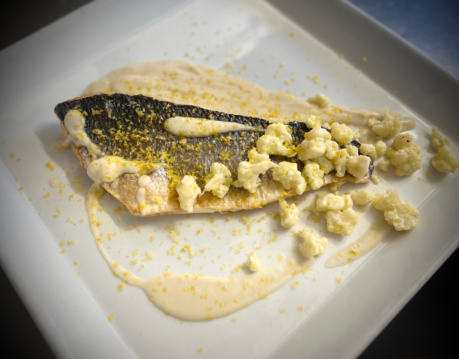 Filetto di branzino, cavolfiore in due consistenze, bottarga di muggine